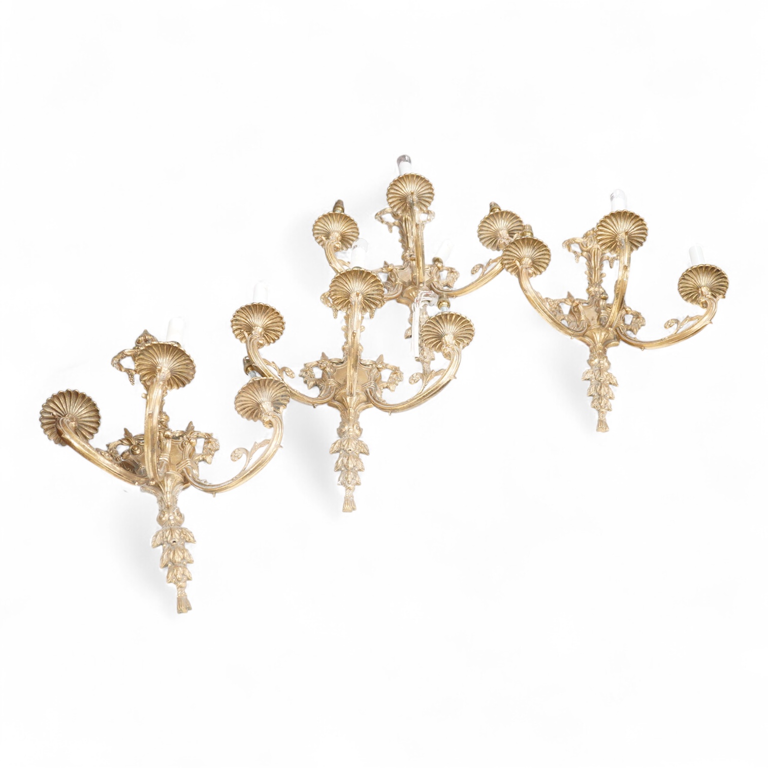 A set of four Louis XVI style three branch gilt bronze wall lights, 62.5cm high x 40cm wide